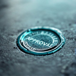 Macro photograph of a teal wax approval seal stamped on thick paper